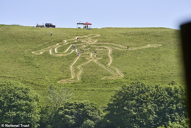 Volunteers and staff restore 180-foot Cerne Abbas Giant with 17 tonnes of chalk.